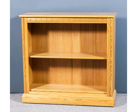 A modern Ercol blonde elm open front bookcase with two adjustable shelves, on plinth base, 38ins wide x 12.5ins deep x 36.5in