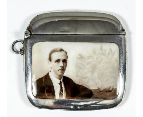 A George V silver and enamel rectangular vesta case, the front enamelled with a shoulder-length portrait of a young man, 2.12