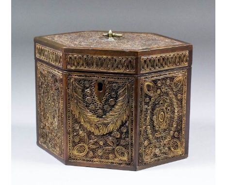 A fine George III curled paper decorated tea caddy of hexagonal form, the panels with extensive gilt detail, with original lo