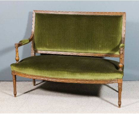 A French beechwood framed two seat settee of "Louis XVI" design, with rectangular ribbon and bead edged back panel and on tur