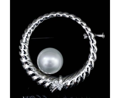 A modern 18k white gold pearl and diamond set circlet pattern brooch, the reeded border with a small butterfly set with rose 