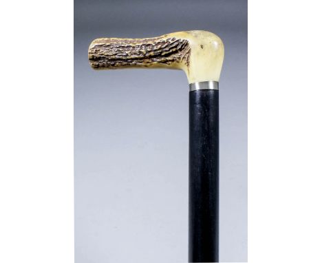 A late 19th/early 20th Century ebonised composite walking stick flick cane, with antler handle, the 3.67in square section ste