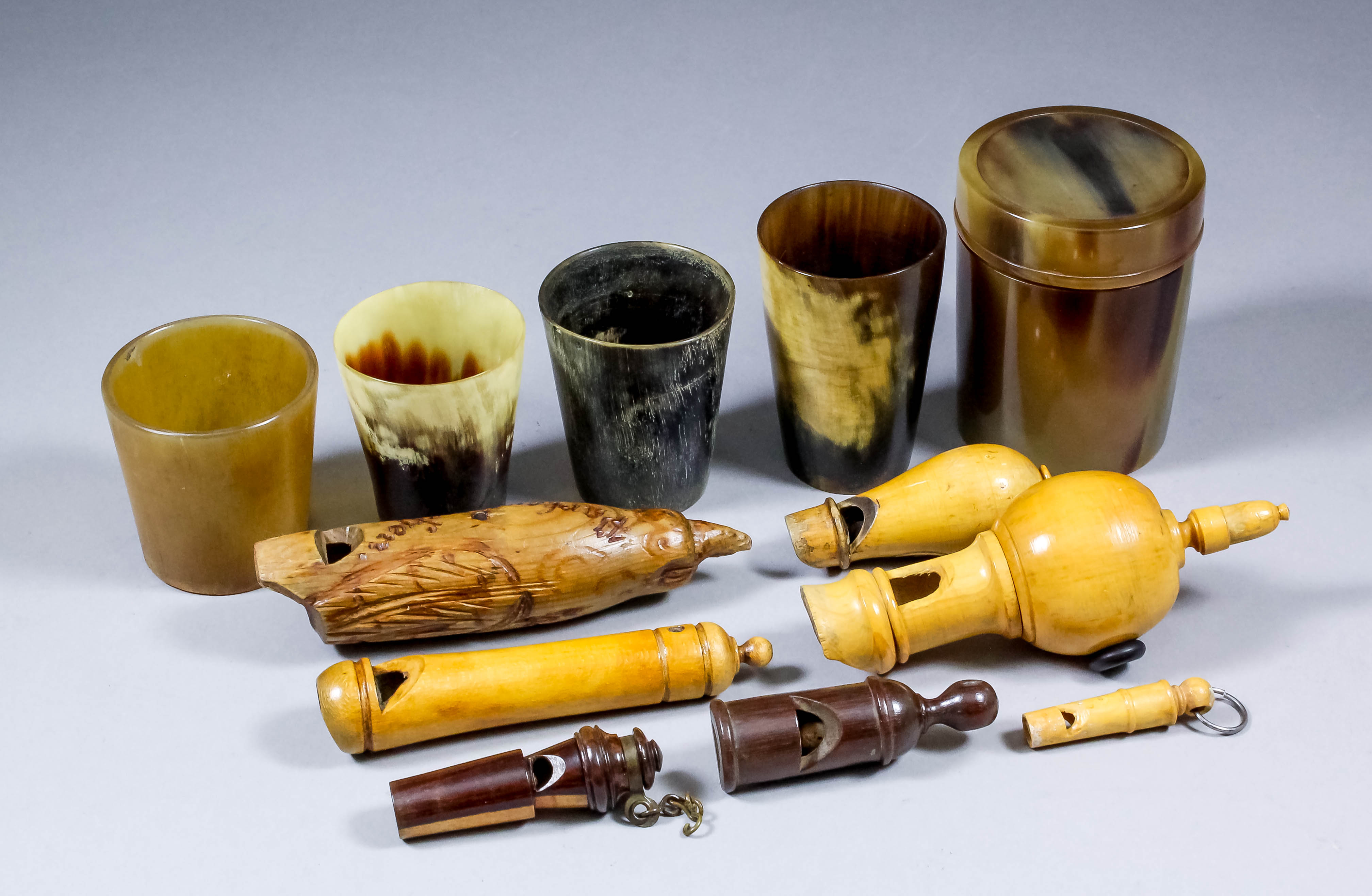 A small selection of turned wood whistles, a small turned bone whistle ...