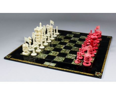 A 19th Century turned and carved ivory and red stained ivory chess set, Kings 3.5ins high, Pawns 1.75ins high, and a Victoria