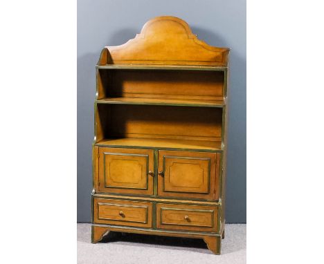 A grained wood and green painted "Waterfall" bookcase with shaped back, fitted two open shelves above cupboard and two small 