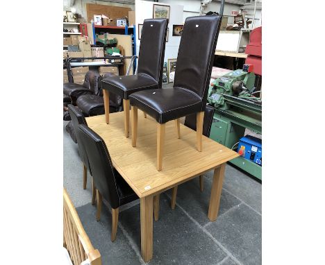 A  light oak dining table with a set of 6 oak framed and brown leather high back chairs 