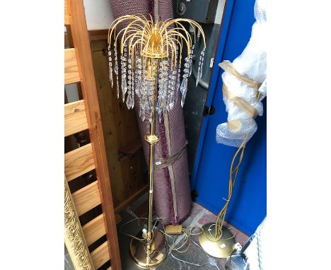 A brass effect standard lamp with glass droplets 