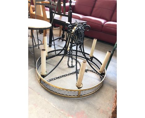 A wrought metal and brass electrified chandelier light fitting 
