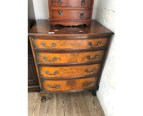 A reproduction bow front walnut chest of drawers 