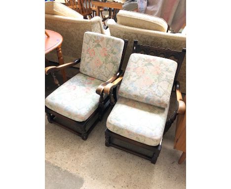 A pair of Ercol priory style low armchairs 