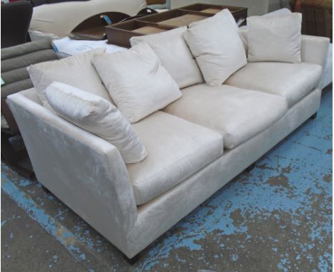 SOFA, in the style of the Bloomsbury sofa by Andrew Martin, upholstered in an ivory velvet with ebonised feet, 226cm L c 100c