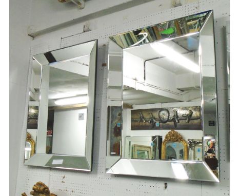 MIRRORS, a pair, bevelled in a mirrored surround, 94cm x 75cm. (2)