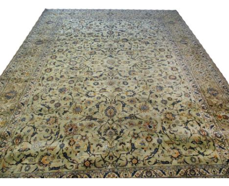 FINE PERSIAN KASHAN CARPET, 435cm x 308cm, all over palmette and vine design on a jade field within corresponding guard strip