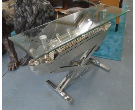 'TITANIC' CONSOLE TABLE, with glass top on chromed base in the form of an ocean liner, 128cm x 43cm x 78cm H.