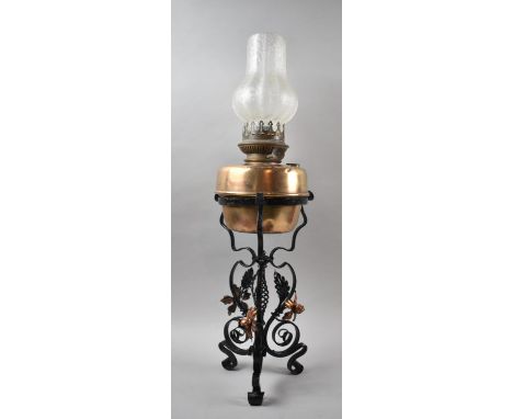 A Mid 20th Century Wrought Iron and Copper Mounted Tripod Oil Lamp with Opaque Shade, 68cm high 