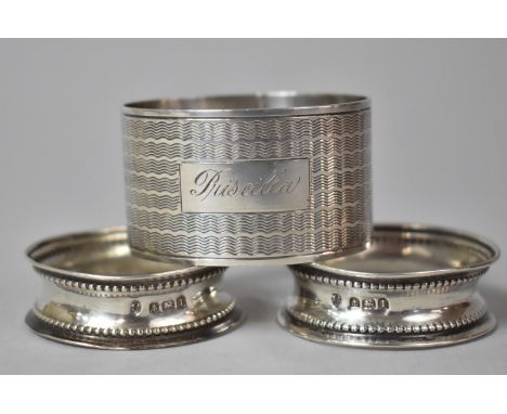 A Pair of Silver Napkin Rings and an Engine Turned Example Inscribed Priscilla 