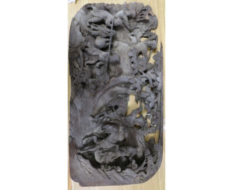 A Chinese wooden panel carved in high relief with a hunting party in a landscape, 29 x 58cm