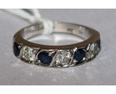 A 18ct white gold seven stone sapphire and diamond half hoop ring, size M.