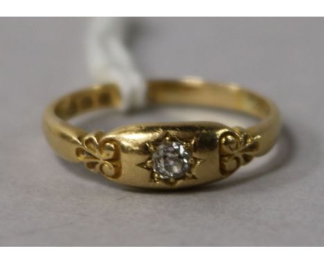 A Victorian 22ct gold and single stone diamond ring with carved shoulders, size P.