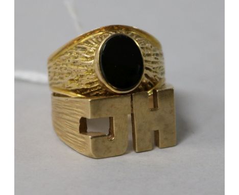 A gentleman's yellow metal and black onyx signet ring (tests as 9ct) and a 'JH' 9ct gold signet ring.