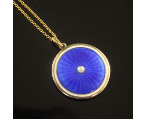 An Edwardian gold, blue guilloche enamel and split pearl circular pendant locket, on a 15ct gold fine link chain, in fitted C