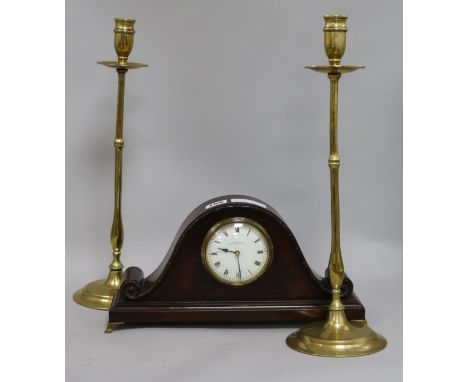 A mantel clock and a pair of brass candlesticks