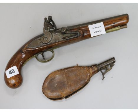 A flintlock pistol and powder flask