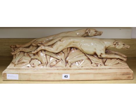 A ceramic Art Deco model of dogs, signed G.H. Gremion