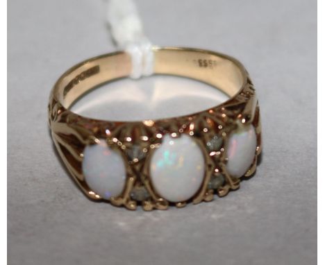 A 9ct gold, three stone white opal and diamond chip set dress ring, size O.