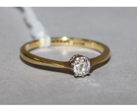 An 18ct gold and platinum solitaire diamond ring, size L.