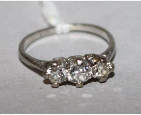 A platinum and three stone diamond ring, size H.