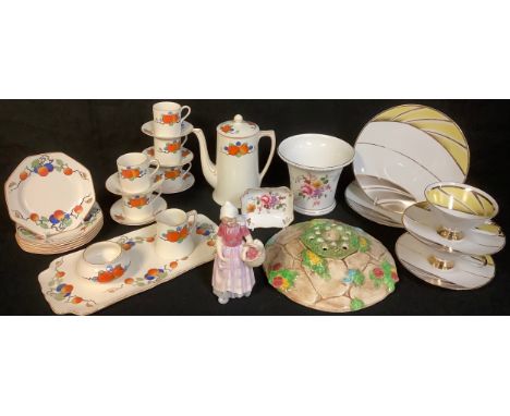 An Art Deco Crown Ducal coffee set for six, printed with ripe oranges, number A1484; a Royal Doulton figure, Annette, HN1550;