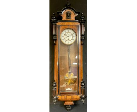 A 19th century walnut Vienna regulator wall clock, the case with shaped pediment applied with a mask and turned finials, c.18
