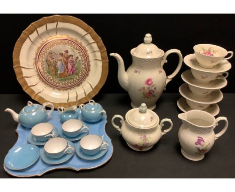 A continental cabaret set, comprising small teapot, cream jug, sugar pot and four cups and saucers, on a tray;  a German coff