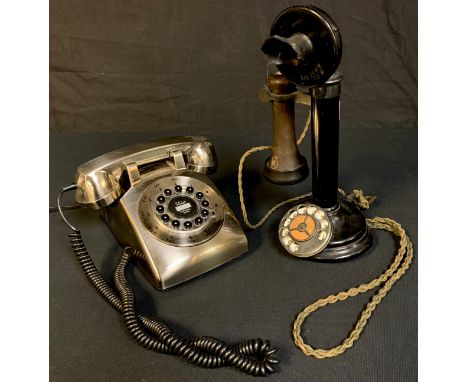 An early 20th century candlestick telephone, Model H28/4001, No.1; a contemporary push button telephone, silvered plastic cas