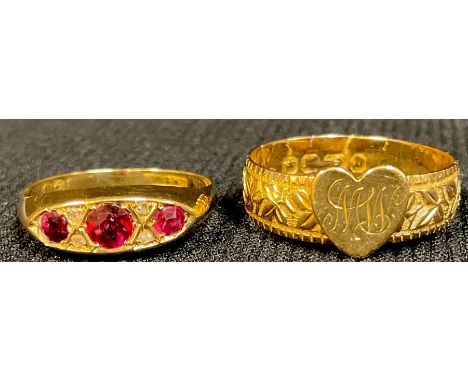 An 18ct gold ring set with ruby and diamond chips, size Q, 2.3g; an 18ct gold ring, engraved and chased, applied with a love 