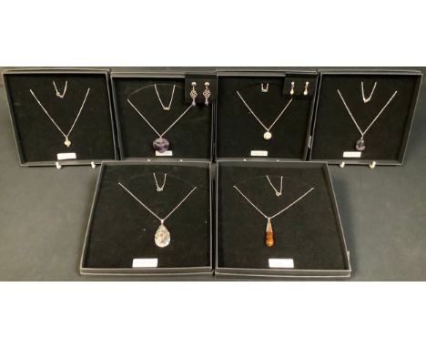 A sterling silver necklace with an amber pendant, marked 925, boxed; other sterling silver necklaces, including heart shaped 
