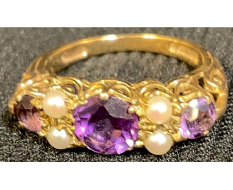 An Edwardian 9ct gold amethyst and seed pearl ring, openwork scrolling bezel, ring size L, London 1909, 2.9g 