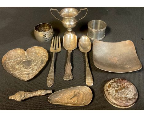 A silver napkin ring, Birmingham 1923; another, Birmingham 1921; a silver heart shaped trinket dish; silver flatware; white m