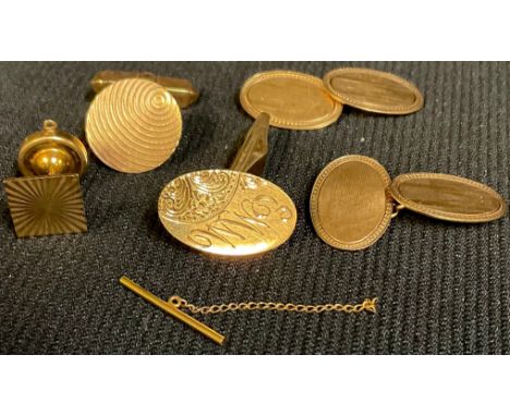 A pair of Art Deco 9ct rose gold oval cuff links, engine turned, Birmingham 1935, 3.4g; two other 9ct gold odd cuff links, 6.