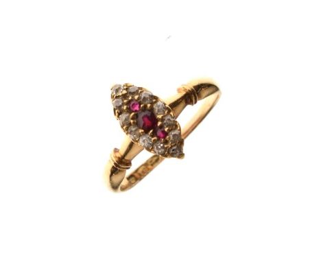 18ct gold dress ring set three ruby coloured stones with a diamond surround in a marquise setting   Condition: 