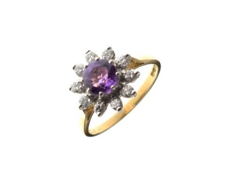 18ct gold diamond daisy cluster ring having purple coloured central stone, size L   Condition: 