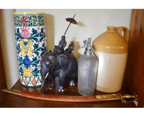 Carved ebonised elephant with two figures seated on its back, circa 1930, together with a Ching & Son of Launceston stoneware