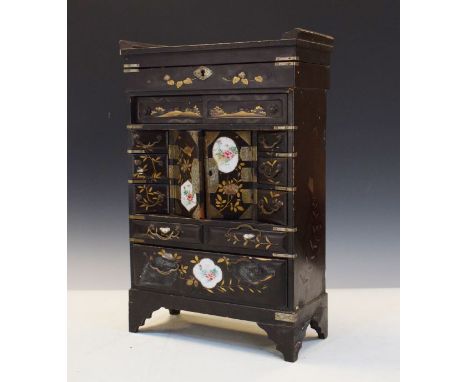 Late 19th Century Japanese lacquered table cabinet having all-over gilt painted decoration and painted porcelain panels, fitt