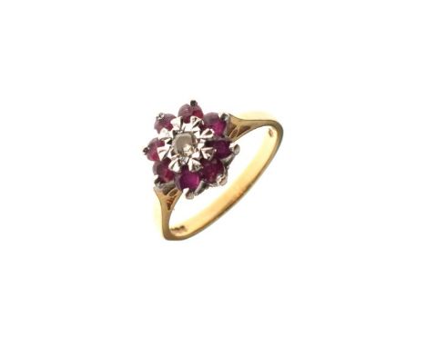 18ct gold daisy cluster ring, the central diamond surrounded by ruby coloured stones, size L   Condition: 