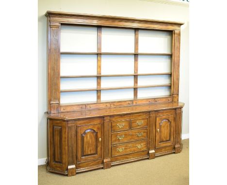 Reproduction American oak dresser, the base fitted three long drawers flanked each side by arched panel doors separated by fl