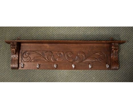 Oak carved panel fitted six chrome coat hooks   Condition: 
