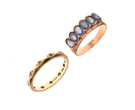 Eternity ring set white stones and a dress ring set six pale blue stones   Condition: 