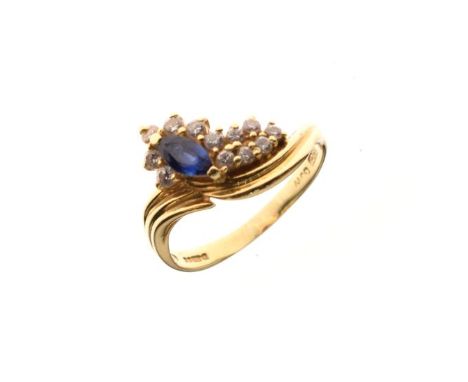 18ct gold dress ring set oval sapphire coloured stone with diamond surround, size P   Condition: 