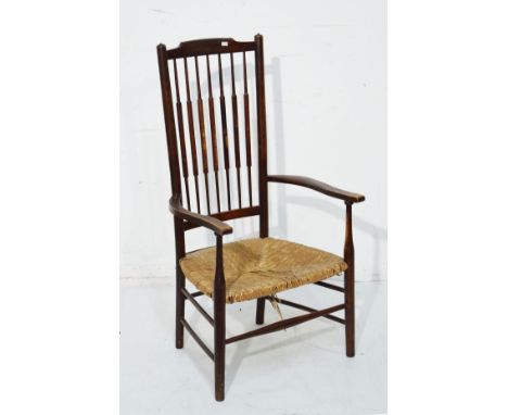 Early 20th Century stained beech stick back low seat fireside elbow chair having a rush seat   Condition: 